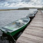 Scopri l’Argentario con il Noleggio Imbarcazioni di Franco Scotto 1 green empty boats on the lake along the wooden pie B4YF6DX